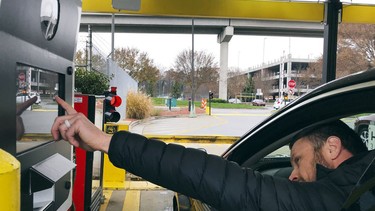 In this Friday, December 7, 2018 photo, a rental car driver demonstrates a new biometric scanning machine by placing his finger on the reader at the Hertz facility at Hartsfield-Jackson Atlanta International Airport, in Atlanta.