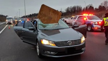 A VW Passat with a piece of plywood lodged in the windshield, taken January 2, 2019 near Brampton