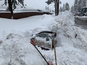 This Feb. 17, 2019 photo provided by City of South Lake Tahoe shows a car buried in snow in South Lake Tahoe, Calif.