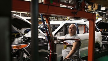 Tony Sada assembles a 2011 Ford Explorer at the Chicago Assembly Plant on December 1, 2010 in Chicago, Illinois.