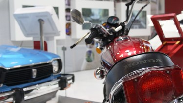 A vintage Honda motorcycle and Civic on display at the Honda stand at the 2019 CIAS.