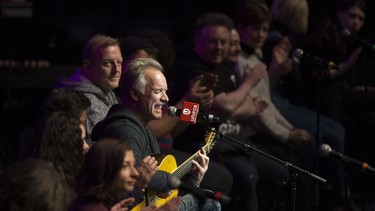UNIFOR National President Jerry Dias sits beside Sting as he performs for GM and UNIFOR employees who will lose their jobs when GM shuts down the Oshawa Plant at the end of the year.