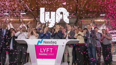 Confetti falls as John Zimmer, co-founder and president of Lyft, center left, and Logan Green, co-founder and CEO of Lyft, center right, ring the opening bell during the company's IPO at Lyft's new service center in Los Angeles on Friday.