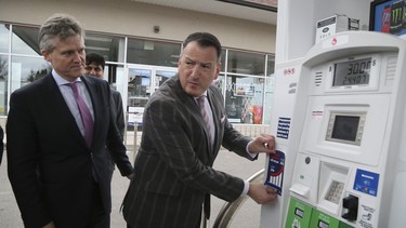 Rob Phillips, Minster of the Environment, Conservation and Parks, left; and Greg Rickford, Minister of Energy, Northern Development and Mines, with an example of the sticker that will be placed on the pumps for participating gas stations was unveiled during a press conference on carbon tax for home heating and gas on Monday April 8, 2019.