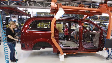 Workers on the production line at Chrysler's assembly plant in Windsor, Ont., work on one of their new minivans on January 18, 2011.