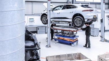 A Jaguar I-Pace having its battery removed