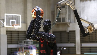 Toyota’s basketball robot Cue 3 demonstrates Monday, April 1, 2019 at a gymnasium in Fuchu, Tokyo. The 207-centimeter (six-foot-10) -tall machine made five of eight three-pointer shots in a demonstration in a Tokyo suburb Monday, a ratio its engineers say is worse than usual.