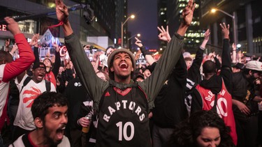 Toronto Raptors fans react as they watch game six of NBA Eastern Conference Final basketball action between the Toronto Raptors and Milwaukee Bucks on a screen outside the Scotiabank Arena, in Toronto on Saturday, May 25, 2019.