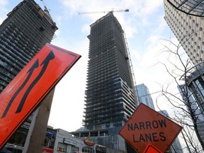Signs warning motorists of a construction zone stand near RioCan's ePlace project, a commercial/residential development in Toronto, Ontario, Canada December 19, 2017.