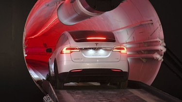 A modified Tesla Model X drives in the tunnel entrance before an unveiling event for the Boring Co. Hawthorne test tunnel in Hawthorne, Calif., Tuesday, Dec. 18, 2018.