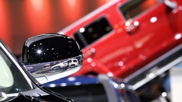 The reflections are seen in the mirror finish of cars on display during the opening day of the 2006 New York International Auto Show at the Jacob Javits Convention Center in New York 12 April 2006.