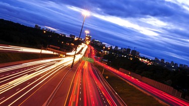 Night traffic on a busy city highway 401 in Toronto