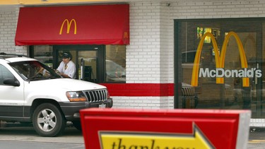 A McDonald's employee assists a customer at its drive-up window August 8, 2003 in Chicago, Illinois.