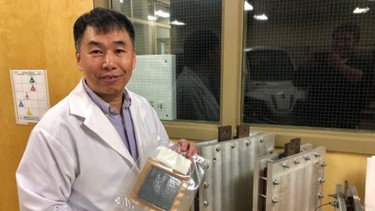 Xianguo Li with a fuel cell