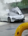 A McLaren Speedtail prototype emitting smoke at a U.K. gas station
