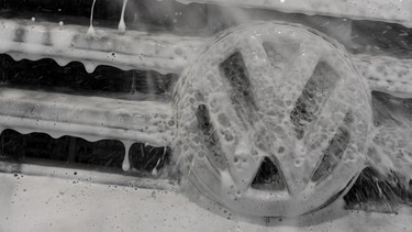 Illustration picture shows the Volkswagen (VW) logo on a car recovered with cleaning foam at a car wash site on January 24, 2017 in Potsdam, near Berlin.