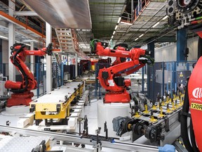 Robots manufactured by Comau are pictured on the assembly line of the Fiat 500 BVE, the first of its kind in Europe, during its inauguration at the Fiat Chrysler Automobiles (FCA) Mirafiori plant in Turin on July 11, 2019.