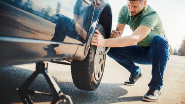 Man changing wheel after a car breakdown.