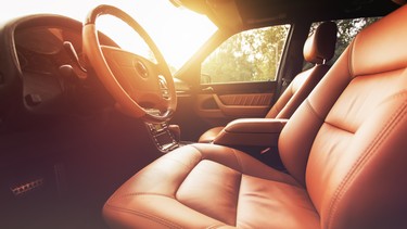 Premium car interior, brown leather at sunset