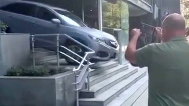 A screenshot from a video of a Vancouver woman driving her Acura SUV down a flight of stairs