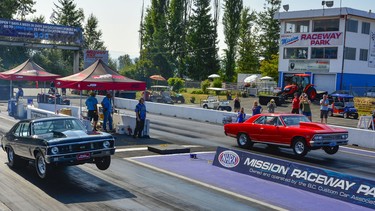Two cars side by side pulling wheelies during last weekend’s Langley Loafer Old Time Drags.