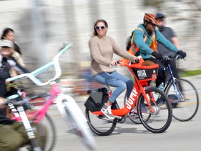 A woman rides an Uber JUMP e-bike in car-free streets during a CicLAvia event in Culver City on March 3, 2019.