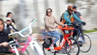 A woman rides an Uber JUMP e-bike in car-free streets during a CicLAvia event in Culver City on March 3, 2019.