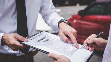 Insurance Agent examine Damaged Car and customer filing signature on Report Claim Form process after accident, Traffic Accident and insurance concept