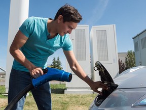 Adrian Dean, a member of the Saskatchewan Electric Vehicle Association, charges his 2011 Nissan Leaf at Petro-Canada's EV Fast Charge station on Regina's east end.