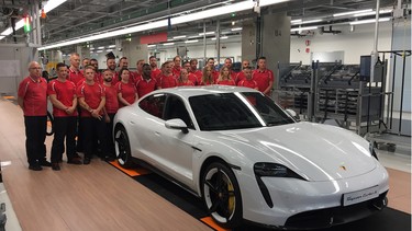 A proud moment for factory workers during the grand opening of the state-of-the-art facility in the Zuffenhausen district of Stuttgart.