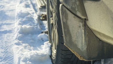 A rear of a vehicle with icicles on the splash guard