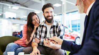 Couple at car showroom dealership buyers shoppers