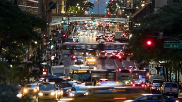 42nd Street is crowded with the busy night lights of crosstown traffic through Midtown Manhattan in New York City NYC