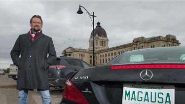 Rod Kletchko stands near the Saskatchewan Legislative Building next to his Mercedes-Benz, which wears a Saskatchewan license plate bearing the letters MAGAUSA.