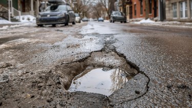 Large deep pothole in Montreal street, Canada.