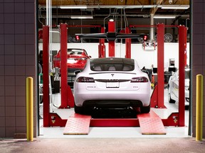 A Tesla Model S in a service garage bay.