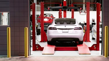 A Tesla Model S in a service garage bay.