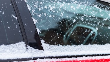 Snow covered car window, macro, close up. Antifreeze was not used. Vehicles in snow. Winter time is coming. Bad weather conditions