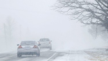 Motorists drive into a near-whiteout caused by snow blowing along Highway 2 Monday, February 25, 2019 between Shannonville and Belleville, Ont. High winds battered the region Sunday and Monday. Such weather has led to calls for Belleville's new warming centre to be open nightly. This image has been altered digitally to obscure a licence plate. Luke Hendry/Belleville Intelligencer/Postmedia Network