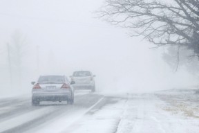 Motorists drive into a near-whiteout caused by snow blowing along Highway 2 Monday, February 25, 2019 between Shannonville and Belleville, Ontario.