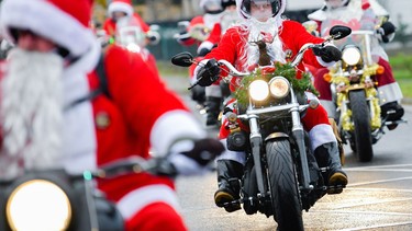 In this file photo, motorcyclists dressed as Santa Claus ride their bikes during a charity event on December 6, 2018 in Lustadt, Germany.