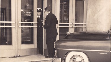 Nick Lucas delivering a new 1951 Dodge Coronet to the steps of the Vancouver tax office as payment for his taxes.