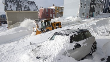 Worker clear snow in St. John’s on Sunday, Jan. 19, 2020. The state of emergency ordered by the City of St. John's continues, leaving businesses closed and vehicles off the roads in the aftermath of the major winter storm that hit the Newfoundland and Labrador capital.