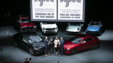 The Jaguar I-PACE, 2020 AJAC Canadian Utility Vehicle of the Year, left, and the Mazda 3, 2020 AJAC Canadian Car of the Year at the 2020 Canadian International AutoShow in Toronto.