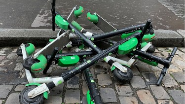 Dock-free electric scooters by California-based bicycle sharing service Lime are stacked on Parisian cobblestones in a street in Paris, France, May 19, 2019.