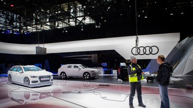 Workers are seen at the stand of German carmaker Audi on February 28, 2020 at the Geneva International Motor Show which has been cancelled after Switzerland banned large gatherings amid the new coronavirus epidemic.