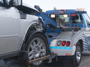 A damaged new vehicle on a tow truck