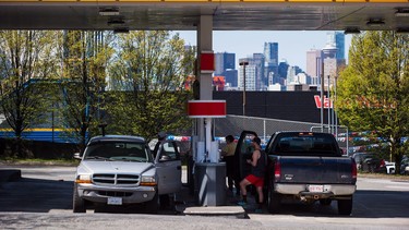 Motorists fuel up vehicles at a gas station in Vancouver, B.C., on Sunday April 22, 2018.