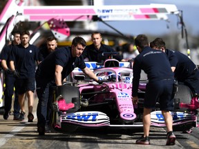 Lance Stroll of Canada driving the (18) Racing Point RP20 Mercedes is helped into the garage by Racing Point team members during Day Two of F1 Winter Testing at Circuit de Barcelona-Catalunya on February 27, 2020 in Barcelona, Spain.