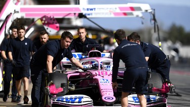 Lance Stroll of Canada driving the (18) Racing Point RP20 Mercedes is helped into the garage by Racing Point team members during Day Two of F1 Winter Testing at Circuit de Barcelona-Catalunya on February 27, 2020 in Barcelona, Spain.